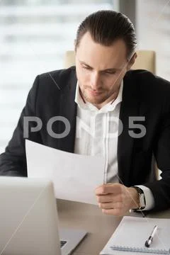 Male entrepreneur reading correspondence Stock Photos