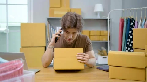 Male entrepreneur is stressed is talking problem on a smartphone to a customer Stock Footage 205597239