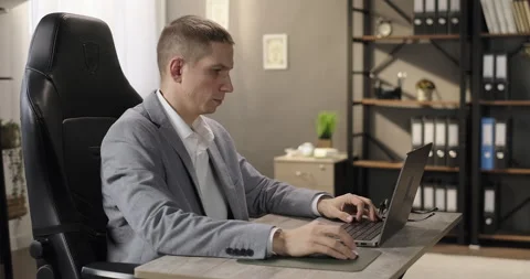 Male entrepreneur working looking at computer laptop screen at office workplace Stock Footage 276843699