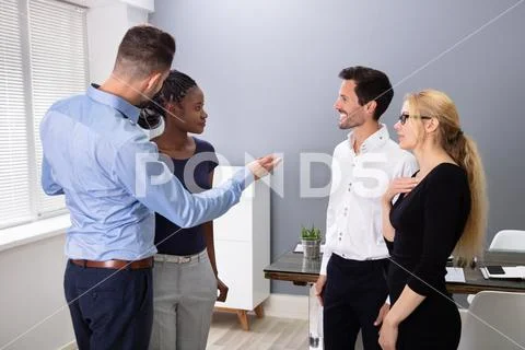 Male Executive Introducing New Hire Employee To His Team Stock Photos