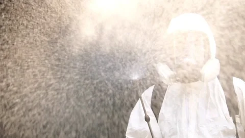 A male expert is spraying a cleaning solution to prevent COVID-19 Stock Footage 147145496