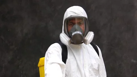 A male expert is spraying a cleaning solution to prevent COVID-19 Stock Footage 147145689