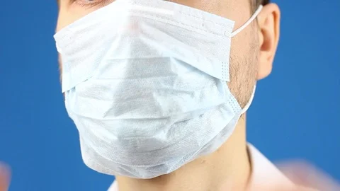 Male face, demonstrate to remove used medical mask, hygiene virus or pollution Video stock 126998973