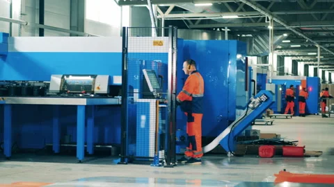 Male factory worker operating a complex modern machine Stock Footage 148332509