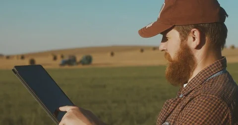 Male farmer with portable tablet computer in a corn field using specialized app Stock Footage 78698907