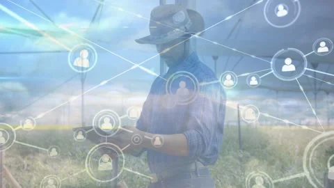 Male farmer tapping tablet in field, activating network nodes and lines while Stock Footage 333277791