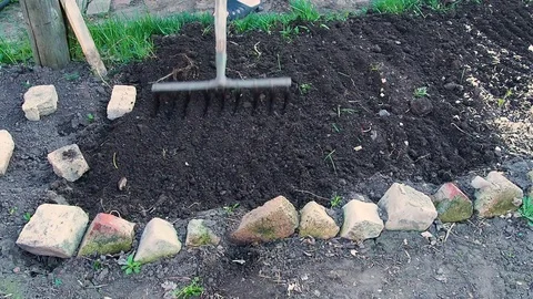 Male farmer using a rake Stock Footage 110986779