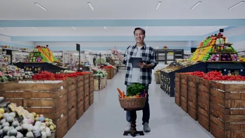 Male Farmer Using Tablet And Pointing To The Side in Grocery Store Stock Footage 311232482