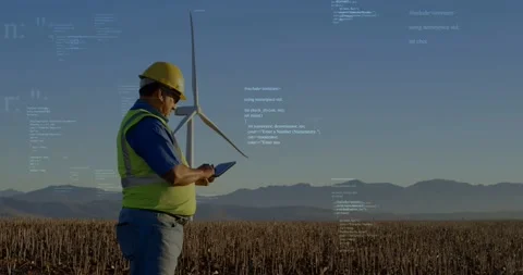 Male field tech tapping tablet and checking turbine data in wind farm, overlays Stock Footage 334115645