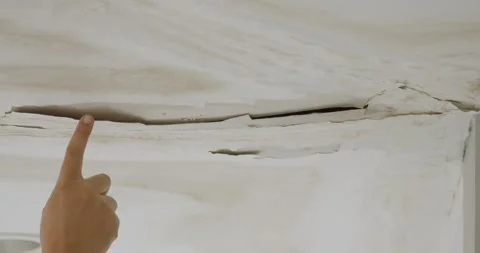 Male finger is peeling paint on ceiling, Office building or house problem. Stock Footage 282382553