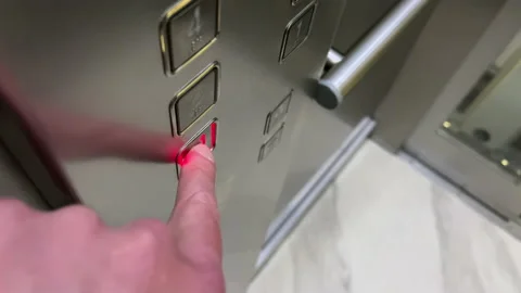 A male finger presses a button on the first floor in a modern elevator Video stock 176499995