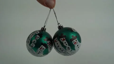 Male finger rotates two self painted christmas balls Stock Footage 246720568