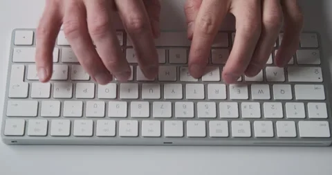Male fingers start typing on computer white keyboard, top view, close-up 動画素材 291673737