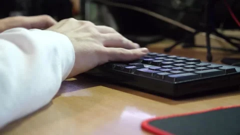 Male fingers typing text on computer keyboard at evening. Arms enter information Stock Footage 306582104