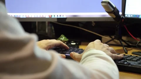 Male fingers typing text on computer keyboard at evening. Guy working Stock Footage 308512481