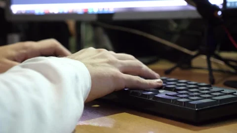 Male fingers typing text on computer keyboard at evening. Arms of young man Stock Footage 324502079