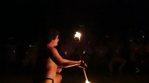 Male fire dancer catches falling flame, performs elaborate juggle, ends show Video stock 68100649