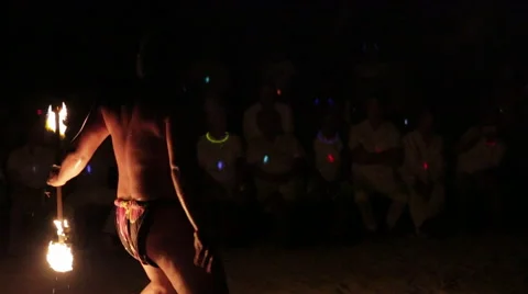 Male fire dancer juggles fire completely around his body several times Video stock 68101192