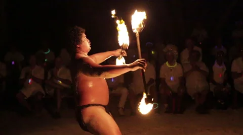 Male fire dancer juggles two spinning fire rings at once - Wide shot Video stock 68101025