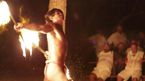 Male fire dancer juggles two spinning fire rings at once Video stock 68101375