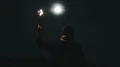 The male with a firework stick walking on the moon background 4k or 4k+ Resolution