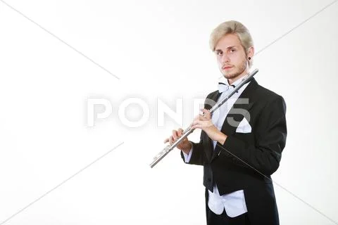 Male flutist wearing tailcoat holds flute Stock Photos