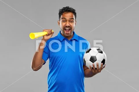 Male football fan with soccer ball and vuvuzela Stock Photos