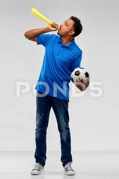 Male football fan with soccer ball and vuvuzela Stock Photos