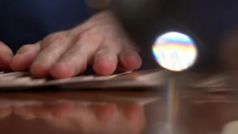 Male fortune teller hands lay out the cards, takes out one and collects it back Stock Footage 162980093
