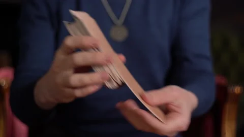 Male fortune teller shuffle a deck of Wait's Tarot cards Stock Footage 163023924