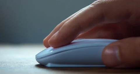 Male freelancer click white computer mouse and scroll internet websites online Stock-Footage 229826264