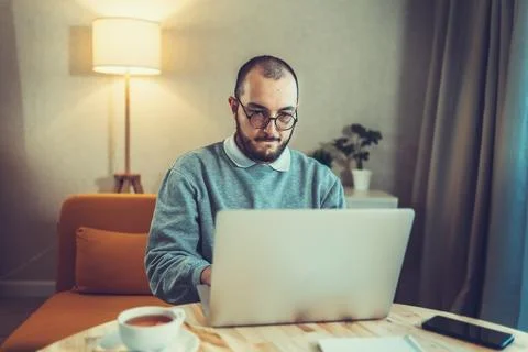 Male freelancer or IT code developer working at laptop. Programmer or young Stock Photos
