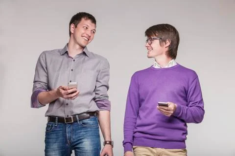 Male friends with phones in hand Stock Photos