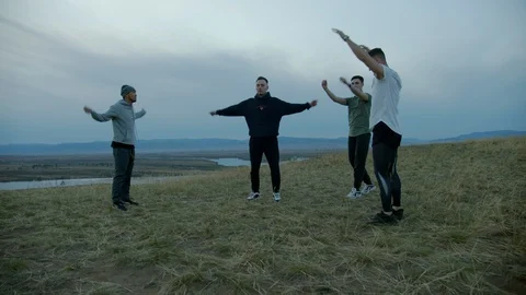Male friends warming up before training outside Stock Footage 130053745