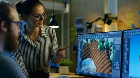 Male Game Developer Talks with Artistic Female Level Designer.  Stock Footage 79391789