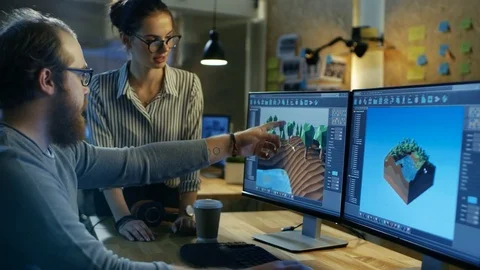 Male Game Developer Talks with Artistic Female Level Designer.  Stock Footage 79395494