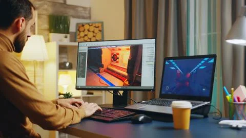 Male game developer typing on keyboard Stock Photos
