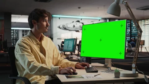 Male Game Developer Using Chromakey Computer In Office Stock Footage 255795671