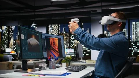 Male game developer using VR glasses and AI tech to design a spaceship 库存照片