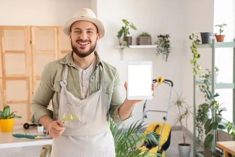 Male gardener with tablet computer in workshop Stock Photos