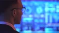 The male in glasses standing near the big display 4k or 4k+ Resolution