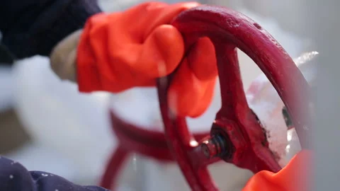 Male with gloves opens or closes valve for entry of gas or biofuel. Man on power Stock Footage 199487516