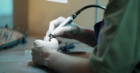 Male goldsmith looking through microscope while making ring Stock Footage 265661268