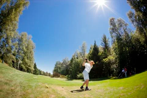  male golf player performs a swing. summer outdoor spo Stock Photos