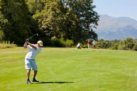 Male golf player performs a swing. summer outdoor spo Stock Photos