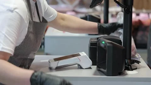 Male Grocery store worker doing checkout scanner for customer shopping cash 動画素材 334644762