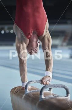 Male Gymnast Performing Upside-Down Handstand On Pommel Horse