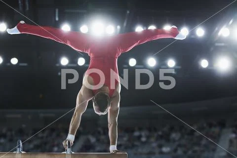Male Gymnast Performing Upside-Down Handstand On Pommel Horse