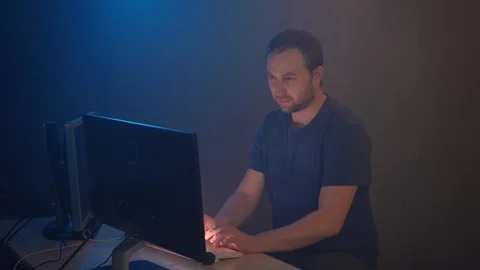 Male hacker is carefully doing his job at the computer. Stock Footage 90979895