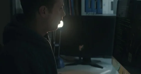 Male hacker in dark office doing cyber crime Stock Footage 78037565